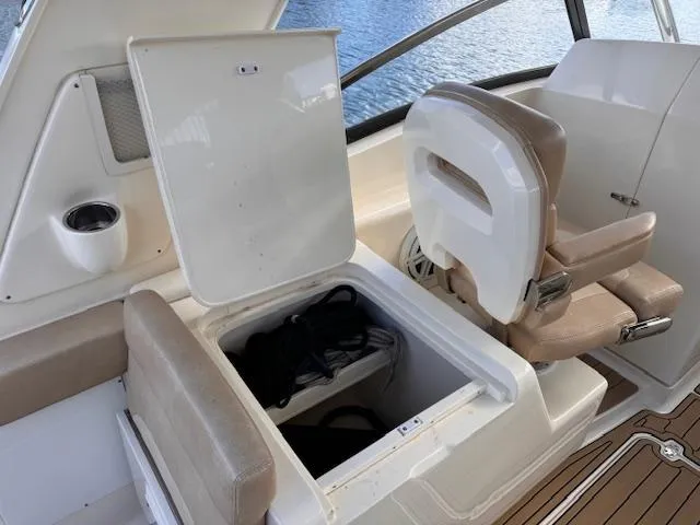 Slide: The Image of 2018 Scout 275 Dorado boat interior with open storage compartment and seating. - 17