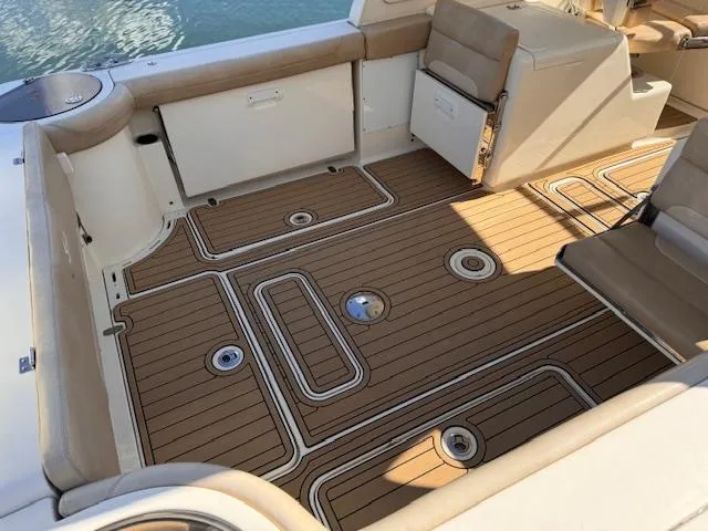 Slide: The Image of 2018 Scout 275 Dorado boat interior with teak flooring and cushioned seating. - 3