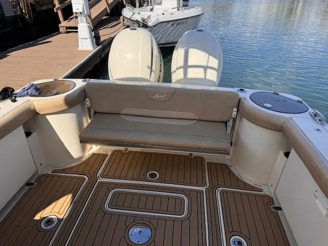 Slide: The Image of 2018 Scout 275 Dorado boat interior with teak flooring and cushioned seating. - 5