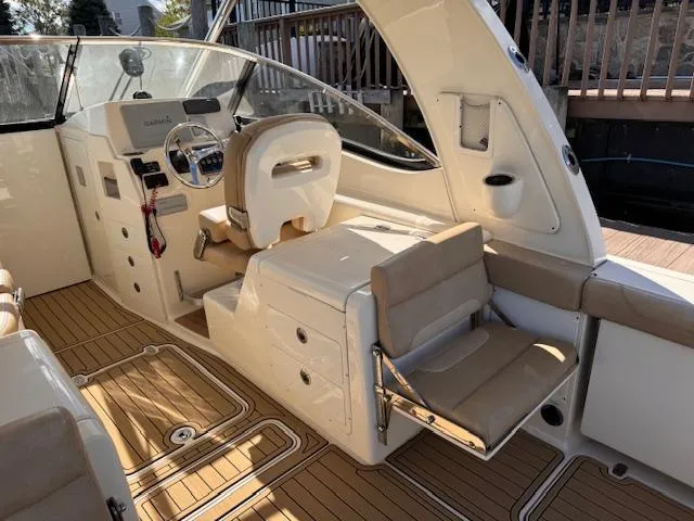 Slide: The Image of 2018 Scout 275 Dorado boat interior with helm, seating, and teak flooring. - 6