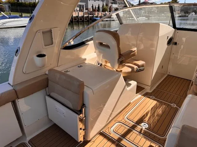 Slide: The Image of 2018 Scout 275 Dorado boat interior with tan seating and wood flooring. - 7