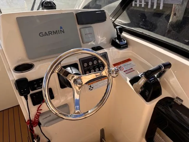 Slide: The Image of 2018 Scout 275 Dorado boat helm with Garmin display and steering wheel. - 8