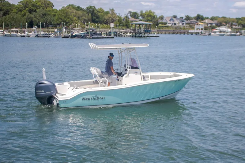 The Image of 2022 NauticStar 2102 Legacy boat cruising on a calm lake. - 1