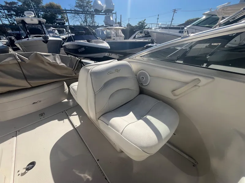 Slide: The Image of 2001 Sea Ray 245 Weekender boat interior with cushioned seating and speaker. - 12