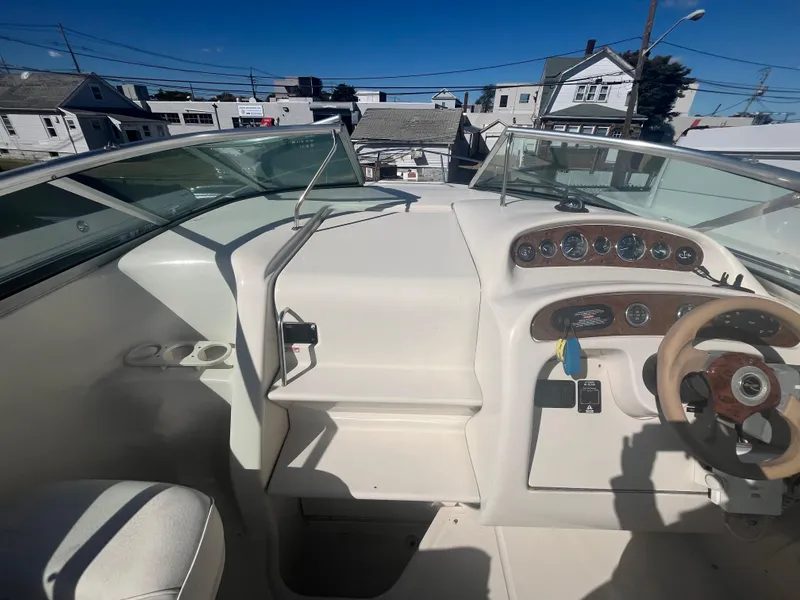 Slide: The Image of 2001 Sea Ray 245 Weekender boat dashboard with steering wheel and instrument panel. - 13