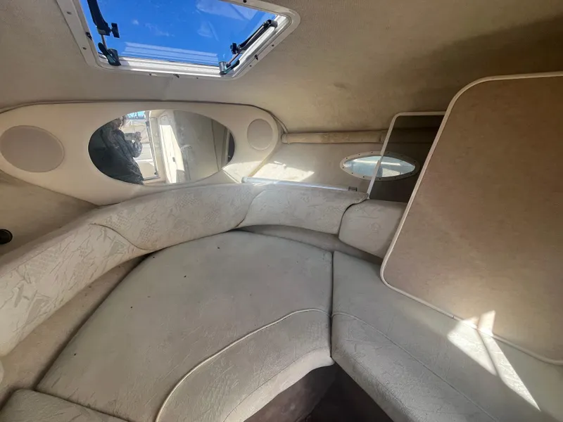 Slide: The Image of Interior cabin of 2001 Sea Ray 245 Weekender boat with beige upholstery. - 16