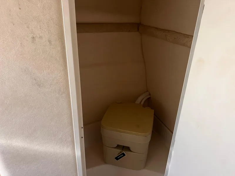 Slide: The Image of 2001 Sea Ray 245 Weekender boat interior with portable toilet. - 19