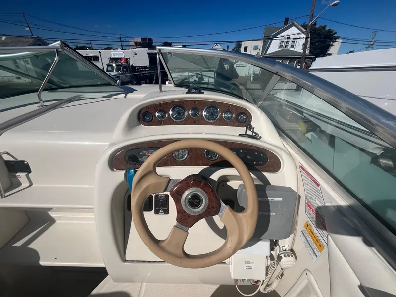 Slide: The Image of 2001 Sea Ray 245 Weekender boat dashboard with steering wheel and gauges. - 8