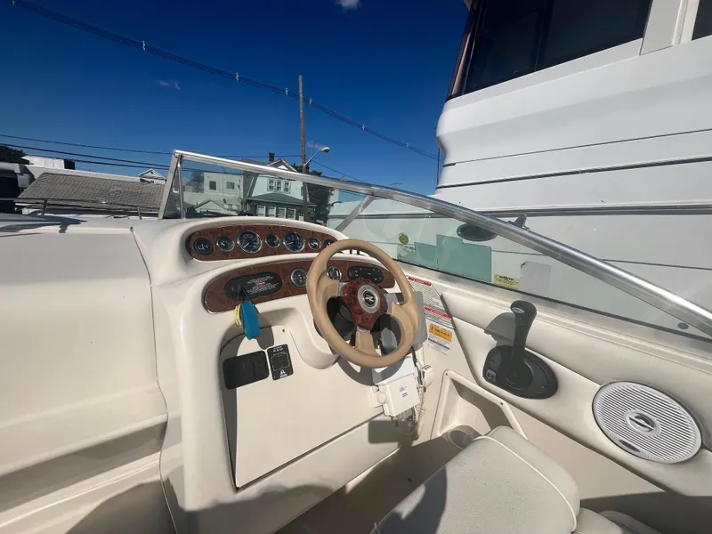 Slide: The Image of 2001 Sea Ray 245 Weekender boat dashboard with steering wheel and gauges. - 9
