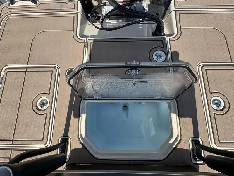 Slide: The Image of 2025 Mako Pro Skiff 18 Backwater Edition deck with open storage compartment. - 10