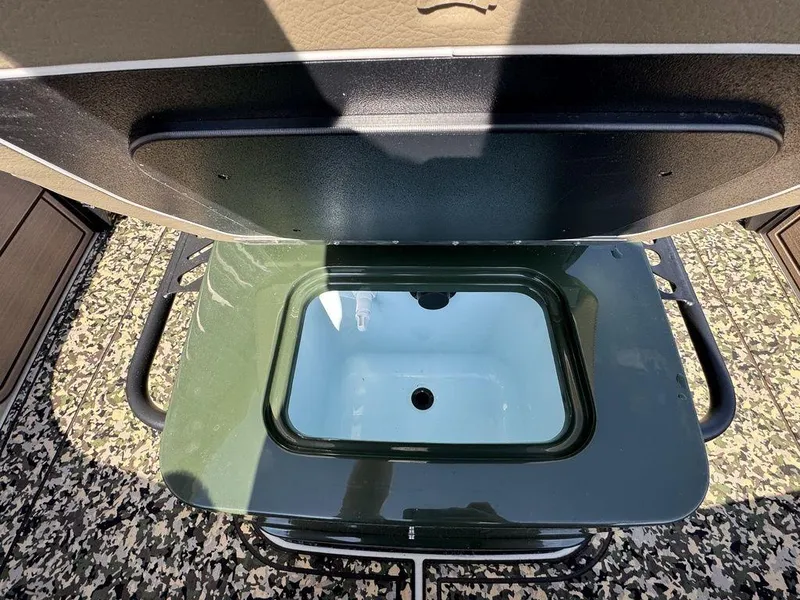 Slide: The Image of Open storage compartment on 2025 Mako Pro Skiff 18 Backwater Edition boat. - 12