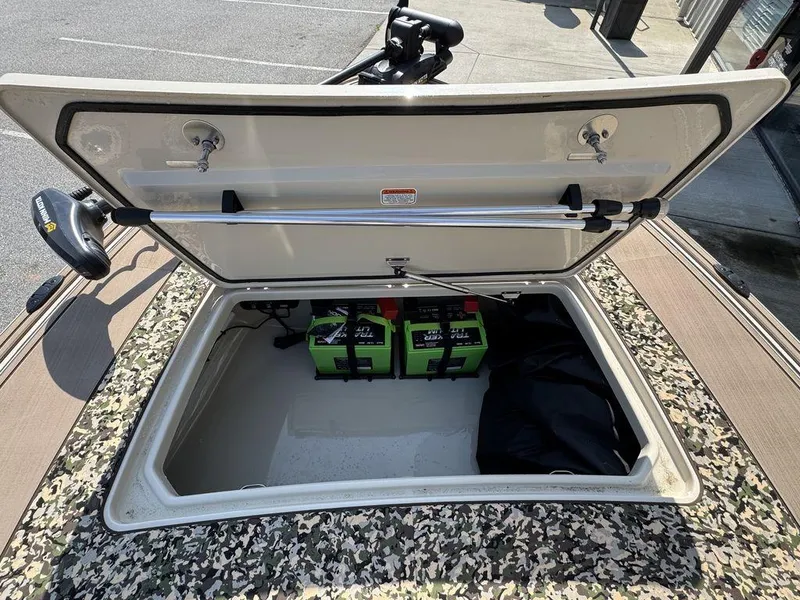 Slide: The Image of Open storage compartment of 2025 Mako Pro Skiff 18 Backwater Edition with batteries inside. - 15