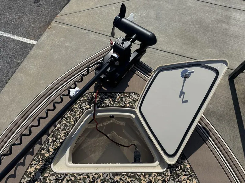 Slide: The Image of 2025 Mako Pro Skiff 18 Backwater Edition with open storage hatch and trolling motor. - 16