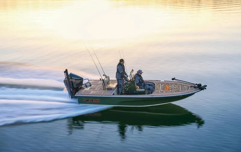 Slide: The Image of 2025 Mako Pro Skiff 18 Backwater Edition speeding on calm water at sunset. - 21