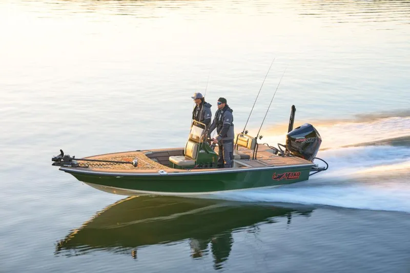 Slide: The Image of 2025 Mako Pro Skiff 18 Backwater Edition cruising on calm water at sunset. - 24