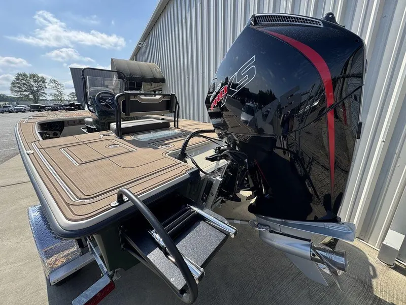 Slide: The Image of 2025 Mako Pro Skiff 18 Backwater Edition with powerful outboard motor, docked outdoors. - 4