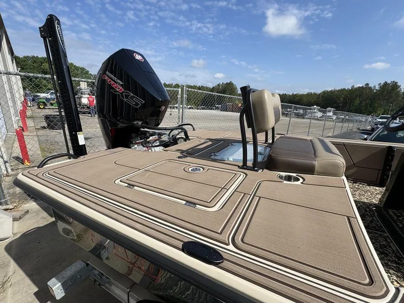 Slide: The Image of 2025 Mako Pro Skiff 18 Backwater Edition boat with outboard motor, parked outdoors. - 5