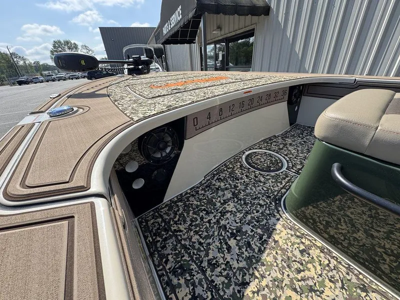 Slide: The Image of 2025 Mako Pro Skiff 18 Backwater Edition with camo interior and advanced dashboard features. - 6