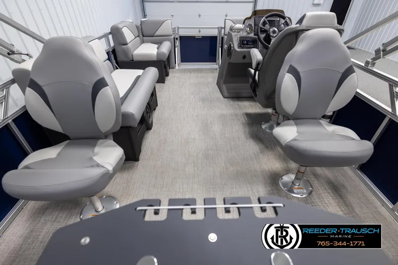 Slide: The Image of 2025 Avalon VEN RF boat interior with gray seating and modern dashboard, Reeder-Trausch Marine branding. - 16