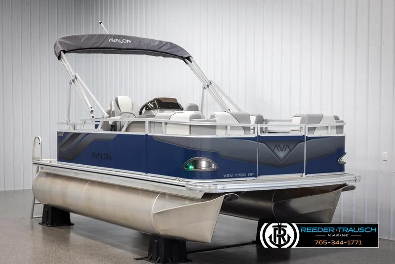 Slide: The Image of 2025 Avalon VEN RF pontoon boat in showroom, featuring sleek design and modern seating. - 2