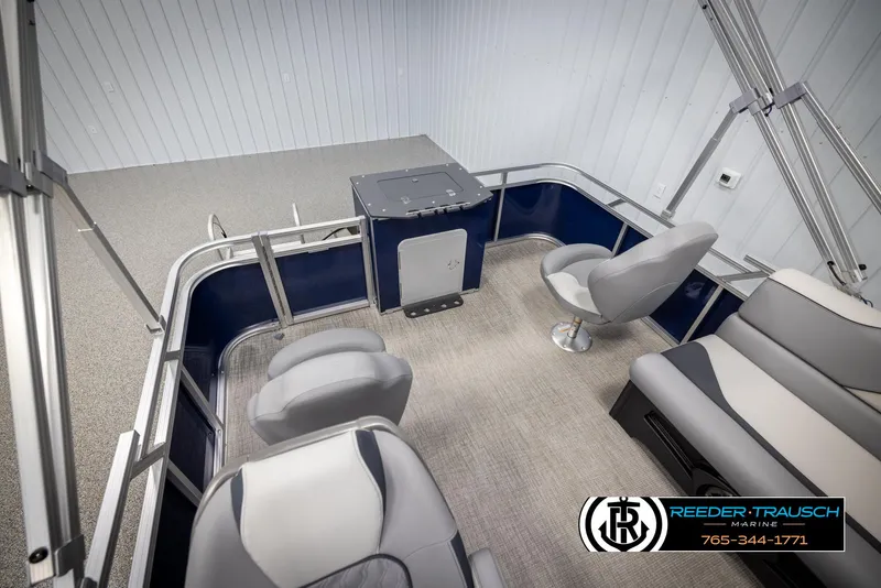 Slide: The Image of Interior of 2025 Avalon VEN RF pontoon boat with gray seating and blue accents. - 22