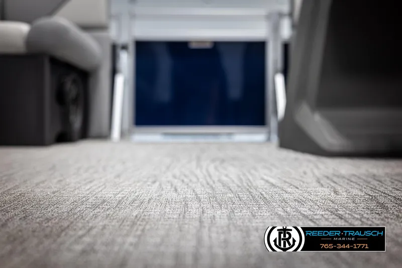 Slide: The Image of Carpeted interior of 2025 Avalon VEN RF boat, featuring Reeder-Trausch Marine branding. - 38
