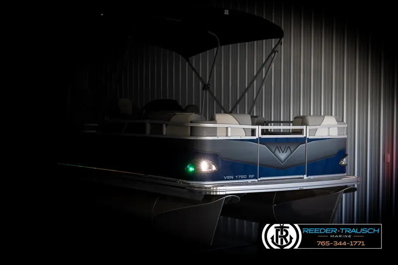 Slide: The Image of 2025 Avalon VEN RF pontoon boat in a dimly lit showroom. - 4