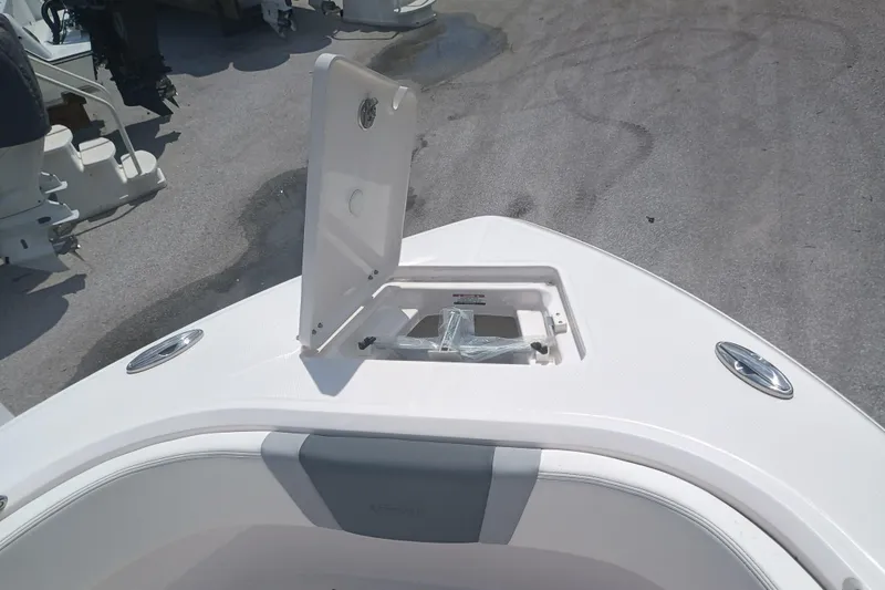 Slide: The Image of 2025 Robalo R230 Center Console boat anchor storage compartment open. - 20