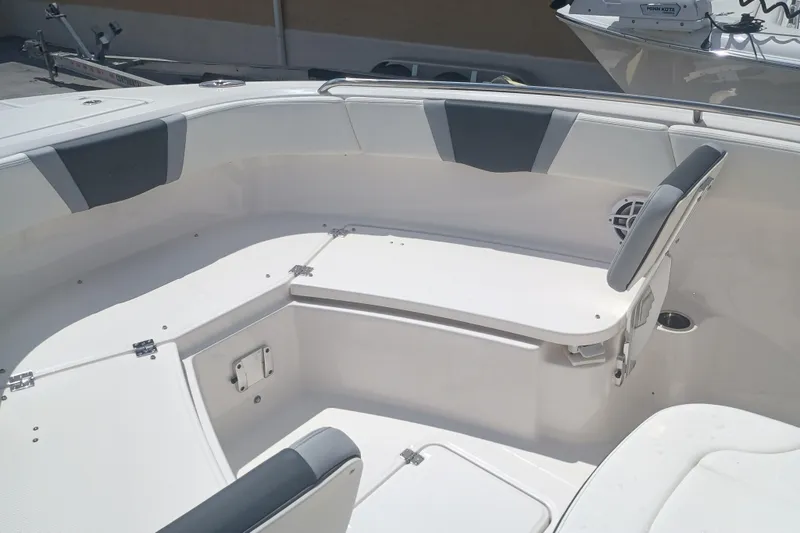 Slide: The Image of 2025 Robalo R230 Center Console boat interior with cushioned seating and storage compartments. - 21