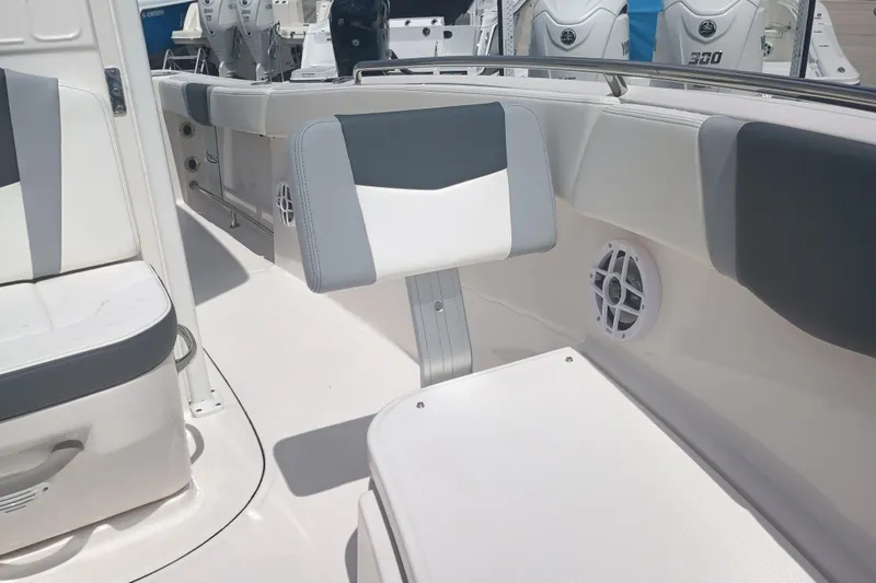 Slide: The Image of 2025 Robalo R230 Center Console boat interior with cushioned seating and modern design. - 24