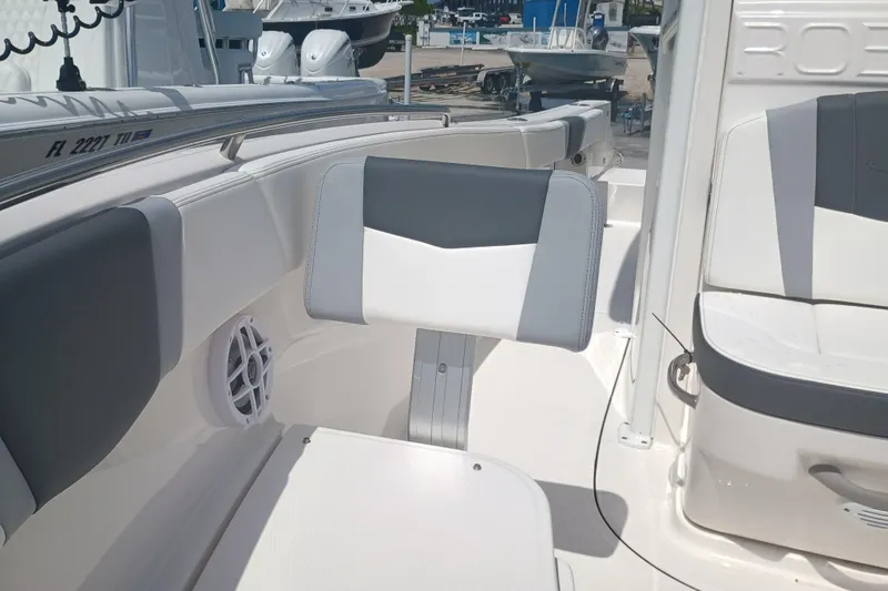 Slide: The Image of 2025 Robalo R230 Center Console boat interior with gray and white seating. - 25