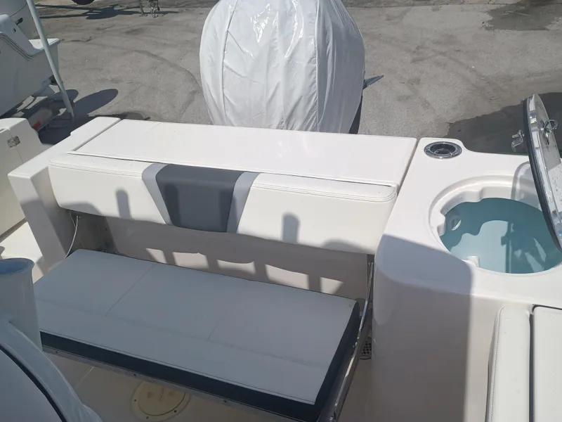 Slide: The Image of 2025 Robalo R230 Center Console boat interior with seating and livewell. - 29