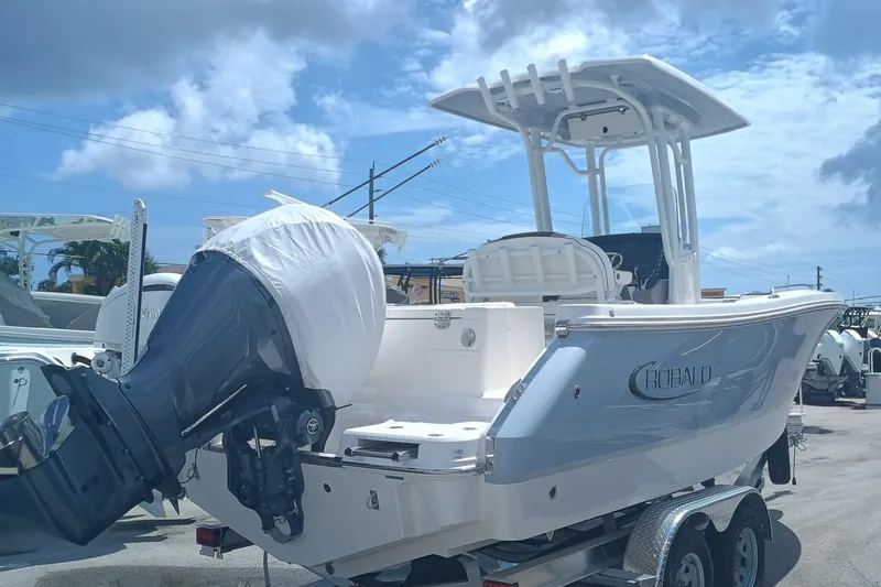 Slide: The Image of 2025 Robalo R230 Center Console boat on trailer under blue sky. - 5