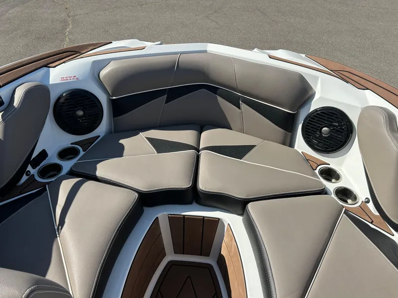 Slide: The Image of 2019 Centurion Fi21 boat interior with cushioned seating and built-in speakers. - 11