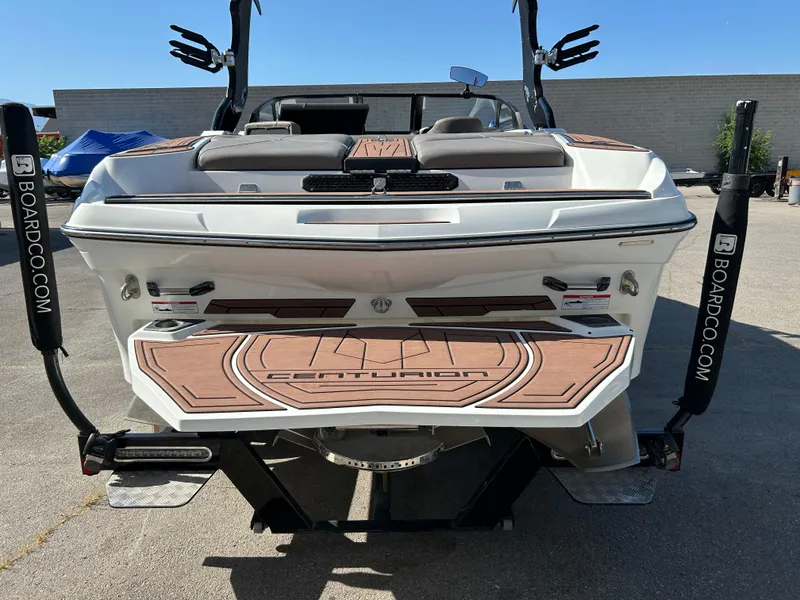 Slide: The Image of 2019 Centurion Fi21 boat rear view with custom deck and wakeboard racks. - 3