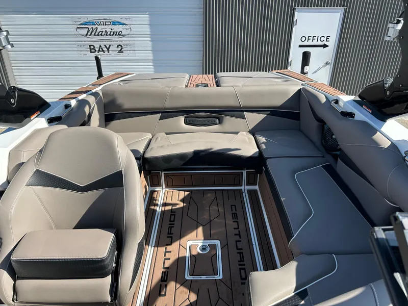 Slide: The Image of 2019 Centurion Fi21 boat interior with gray seating and wood flooring. - 5