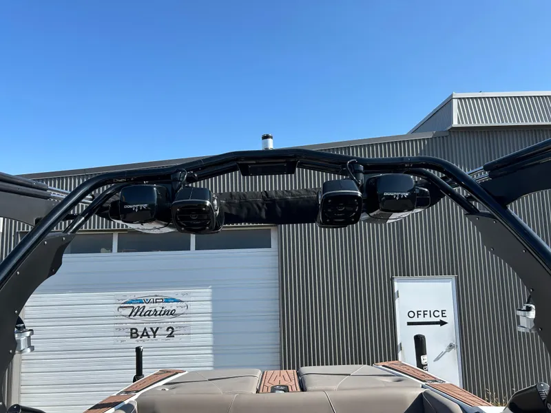 Slide: The Image of 2019 Centurion Fi21 boat with speakers, docked near marina office. - 8