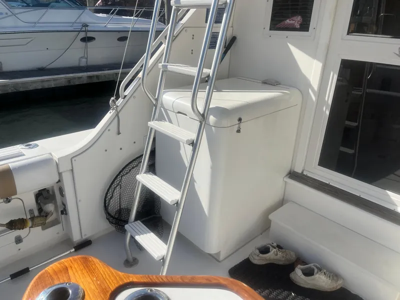 Slide: The Image of Bertram 37 Convertible 1993 yacht interior with ladder and storage compartment. - 15