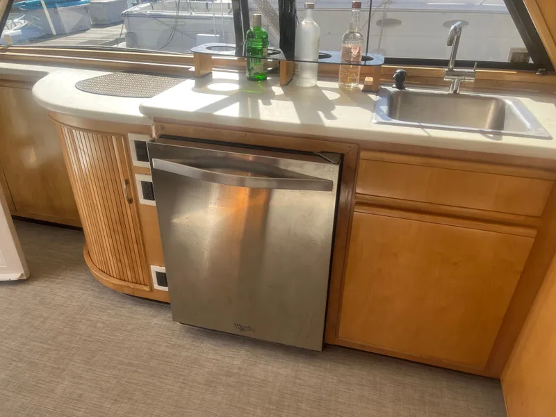 Slide: The Image of 1993 Bertram 37 Convertible yacht kitchen with sink, dishwasher, and countertop. - 19
