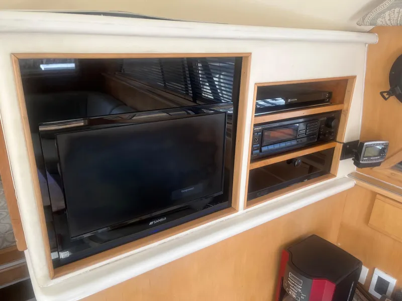 Slide: The Image of Entertainment system inside 1993 Bertram 37 Convertible yacht, featuring a TV and audio equipment. - 20