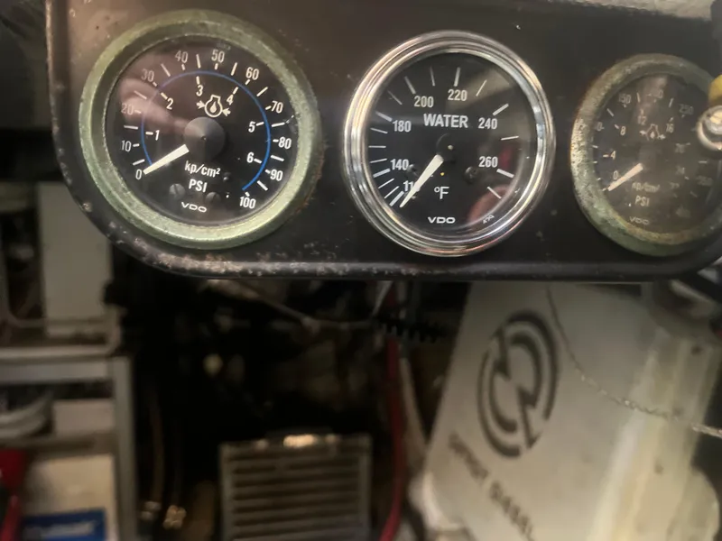 Slide: The Image of Close-up of 1993 Bertram 37 Convertible engine gauges displaying PSI and water temperature. - 24