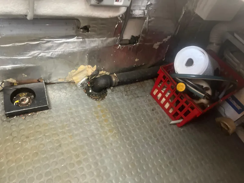 Slide: The Image of Engine room of 1993 Bertram 37 Convertible with tools and piping. - 29