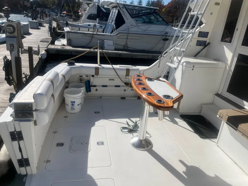 Slide: The Image of 1993 Bertram 37 Convertible boat deck with fishing rod holders and seating. - 3