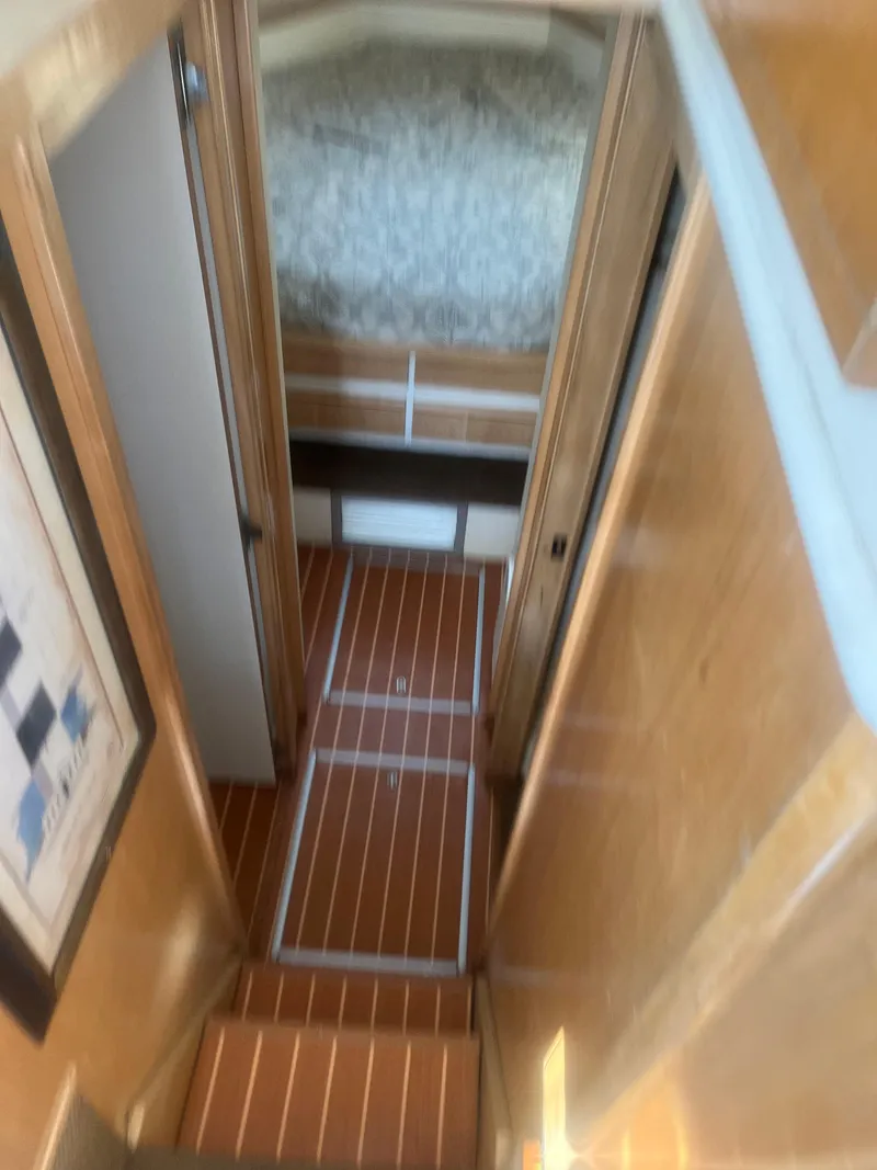 Slide: The Image of Interior of 1993 Bertram 37 Convertible yacht with wood flooring and cozy cabin. - 30