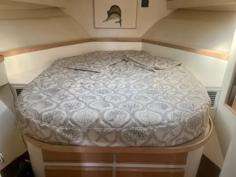Slide: The Image of Cozy cabin bed in 1993 Bertram 37 Convertible yacht with patterned bedding. - 33
