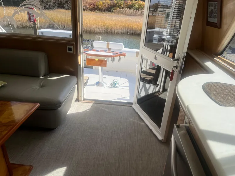 Slide: The Image of Interior of 1993 Bertram 37 Convertible yacht with open door to deck. - 38