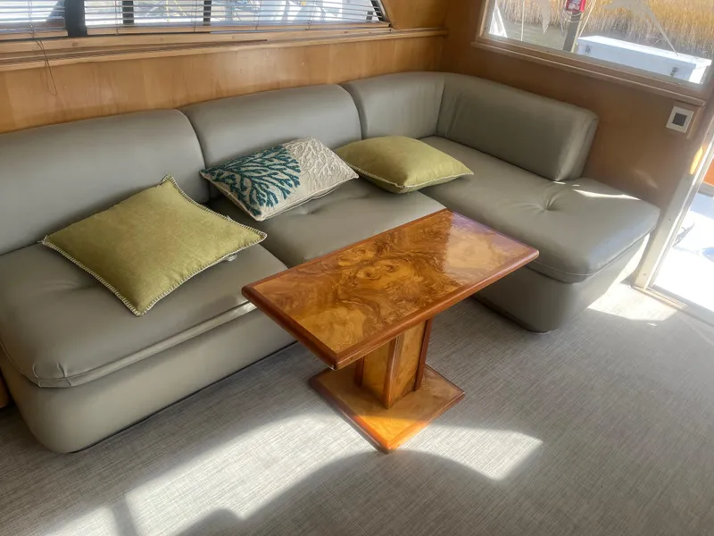 Slide: The Image of Luxurious interior of 1993 Bertram 37 Convertible with elegant sofa and wooden table. - 39