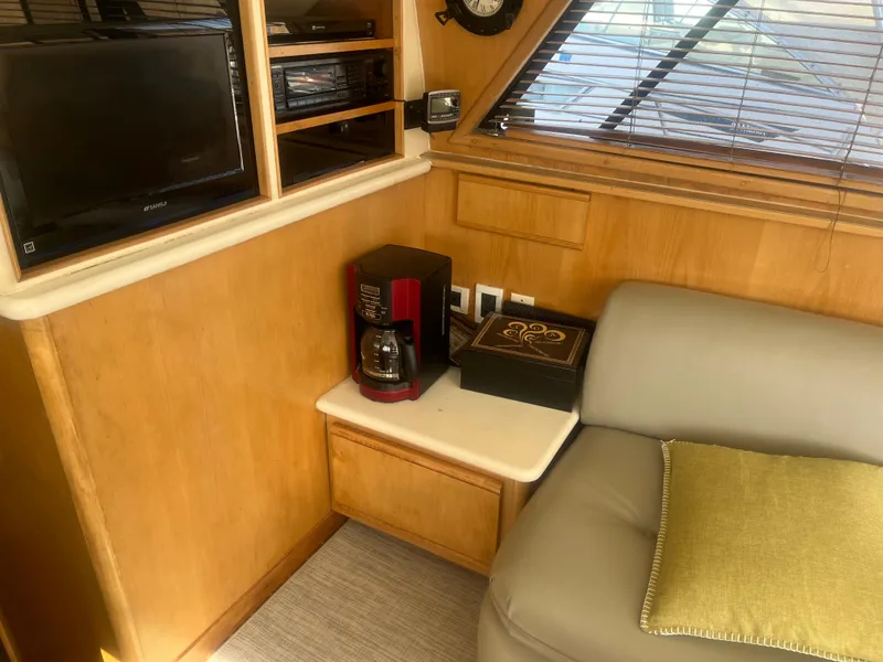 Slide: The Image of Cozy interior of 1993 Bertram 37 Convertible with TV, coffee maker, and sofa. - 41