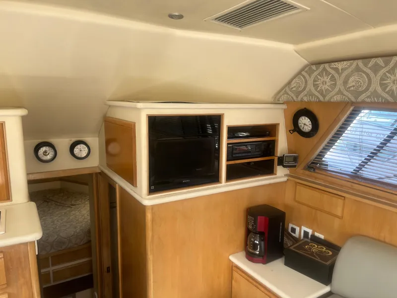 Slide: The Image of Interior of 1993 Bertram 37 Convertible yacht with entertainment center and coffee maker. - 42