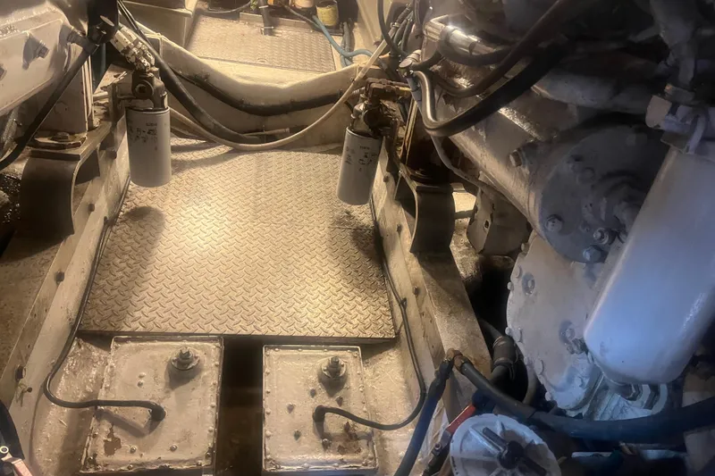 Slide: The Image of Engine room of a 1993 Bertram 37 Convertible boat, showcasing mechanical components. - 50